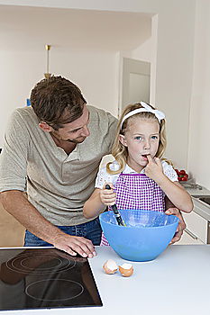 Similar – Woman feeding her little girl in kitchen