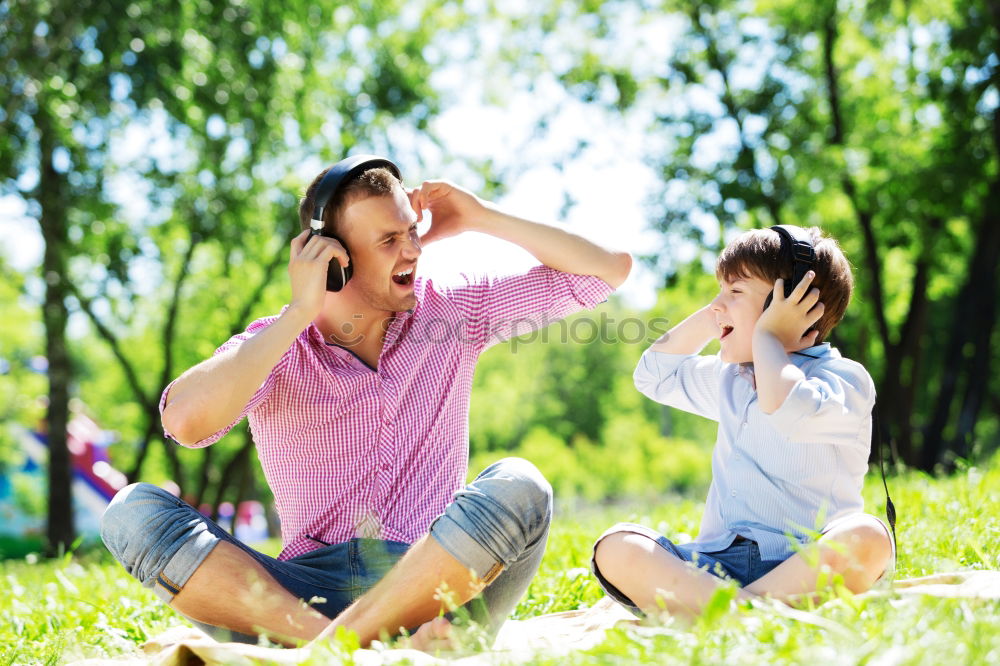 Similar – Image, Stock Photo Father and son relaxing near the house at the day time. They sitting near are the colorful wall. Concept of friendly family.