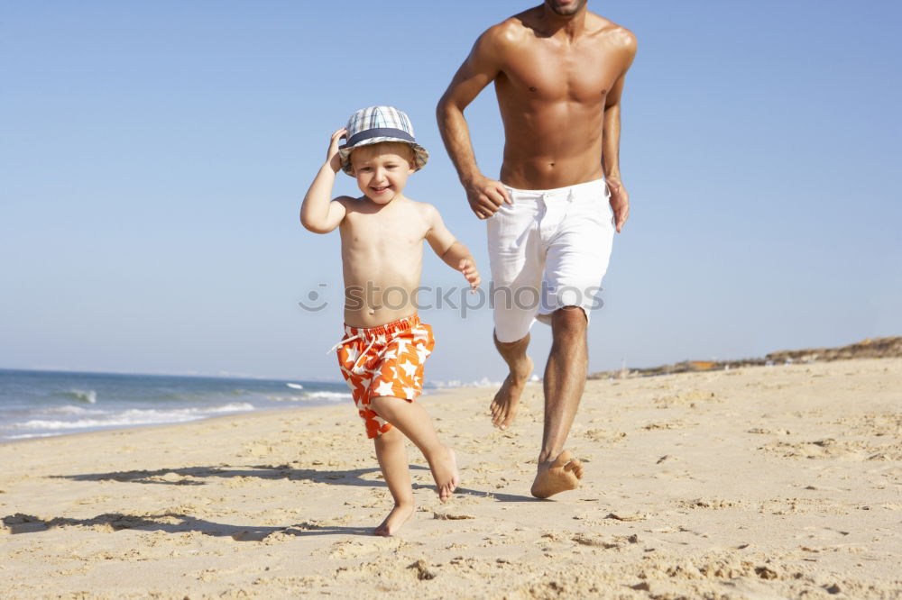 Similar – Image, Stock Photo Father and son playing football on the beach at the day time. Concept of friendly family.