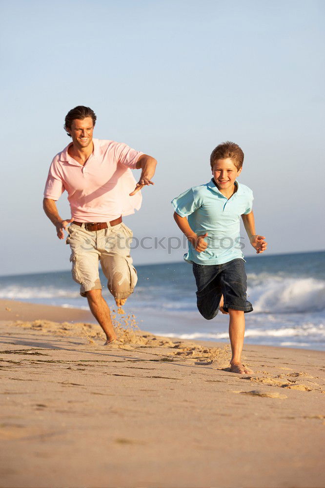 Similar – Image, Stock Photo Father and son playing football on the beach at the day time. Concept of friendly family.