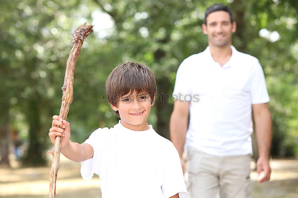 Similar – Image, Stock Photo Cheerful young man teaching his son to play mini golf