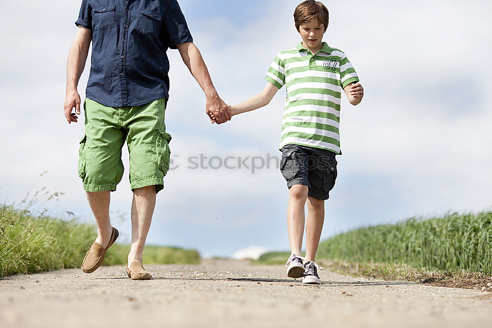 Similar – Father and son playing on the road at the day time.