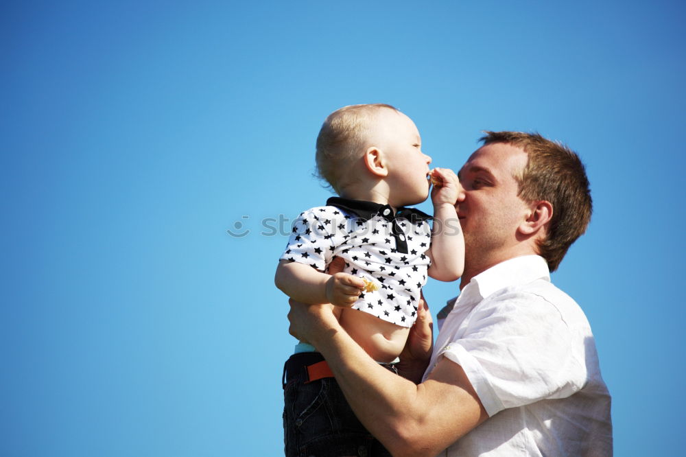 Father and son playing in the park at the day time.