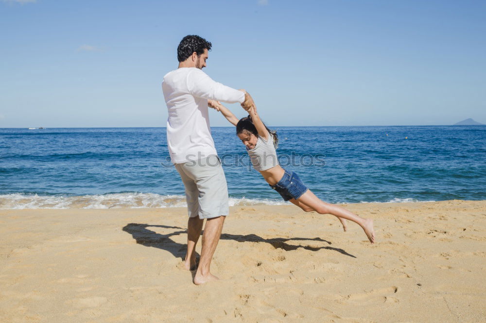 Similar – Father and daughter playing on the beach at the day time.