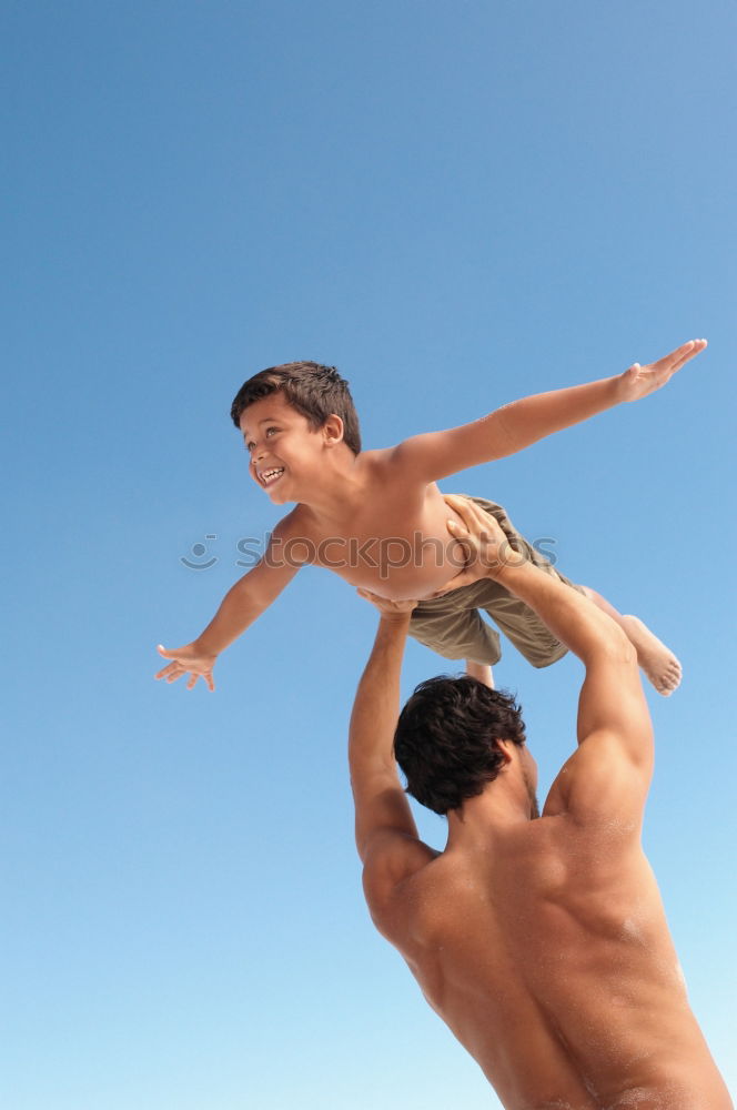 Similar – Image, Stock Photo Father and son playing on the beach at the day time. They are dressed in sailor’s vests. Concept of sailors on vacation and friendly family.