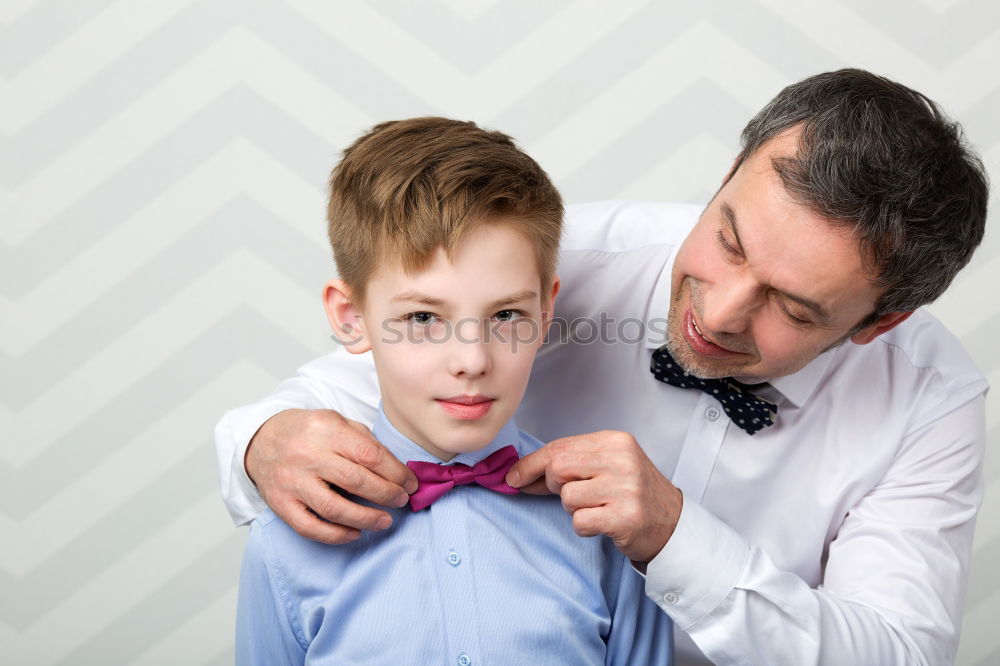 Image, Stock Photo Father helping son to adjust a bowtie. Preparation before important event