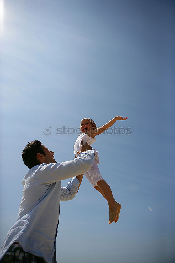 Image, Stock Photo Father and son playing on the beach at the day time. They are dressed in sailor’s vests. Concept of sailors on vacation and friendly family.