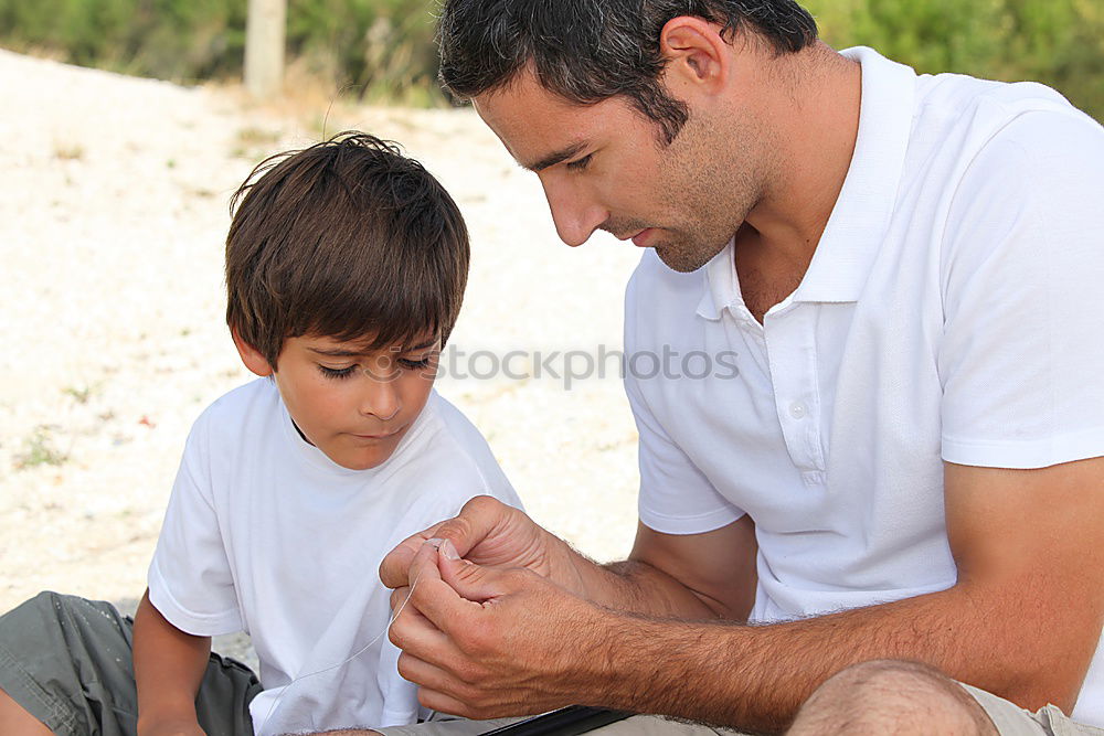 Similar – Image, Stock Photo Cheerful young man teaching his son to play mini golf