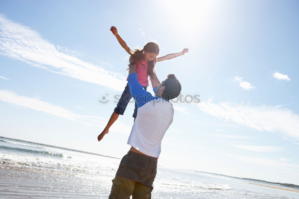 Similar – Father and daughter with balloons playing on the beach