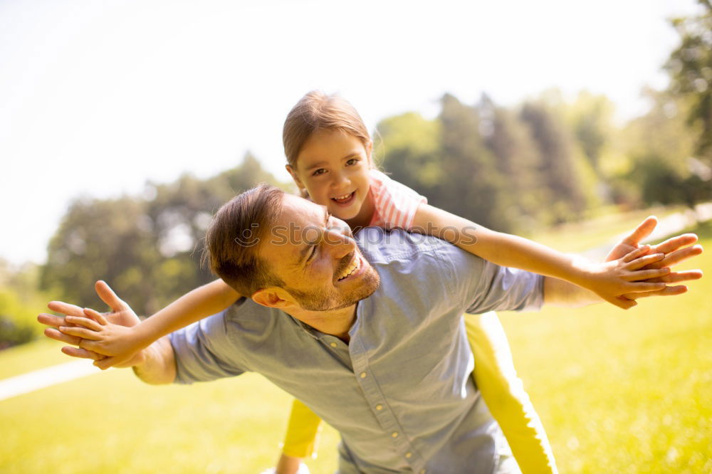 Similar – Image, Stock Photo Father and son relaxing near the house at the day time. They sitting near are the colorful wall. Concept of friendly family.