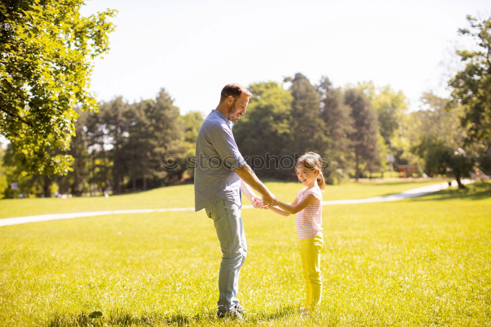 Similar – Image, Stock Photo Father and son relaxing near the house at the day time. They standing near are the colorful wall. Concept of friendly family.