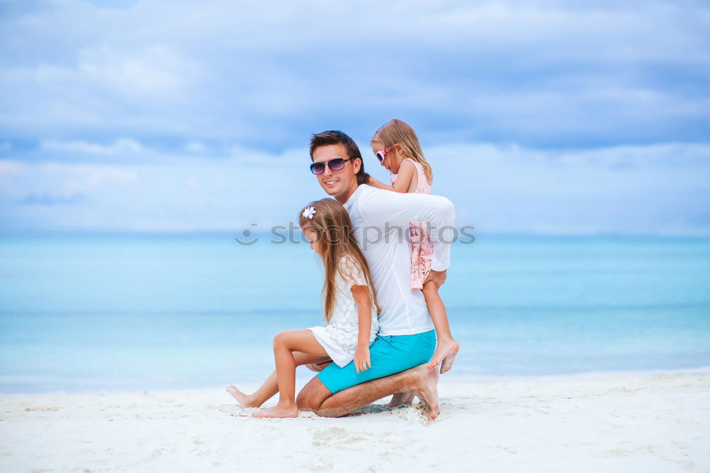 Similar – Father and daughter playing on the beach at the day time.