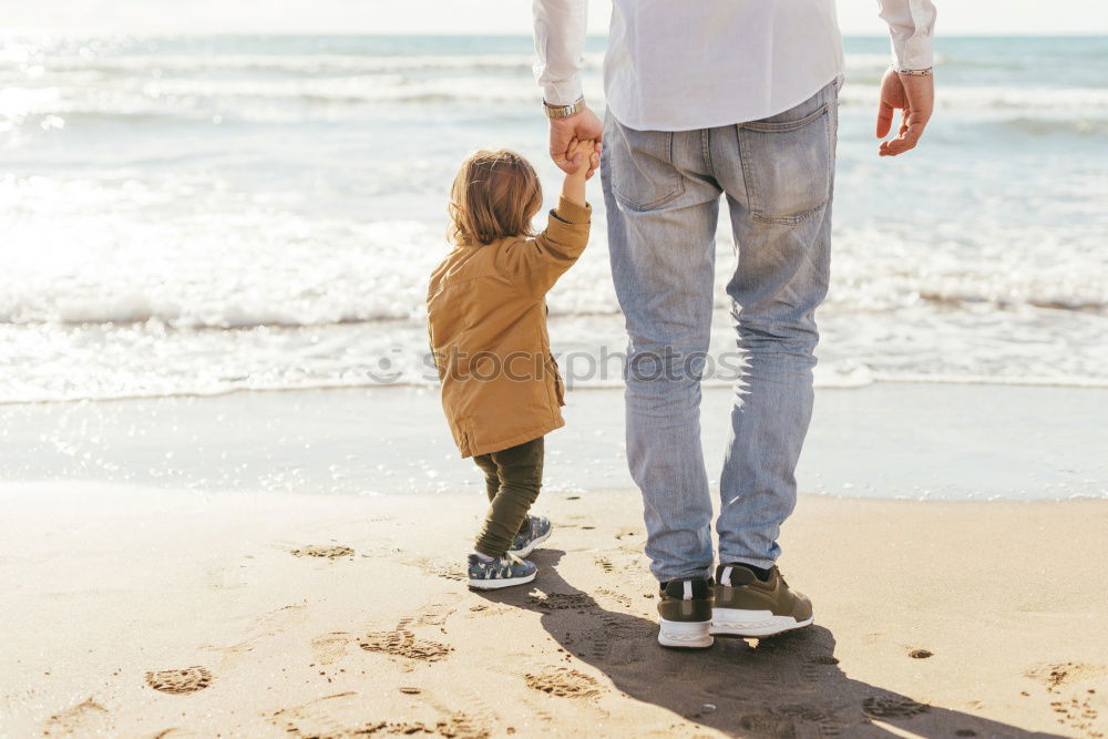 Similar – Grandfather With His grandson on the lake. Back view