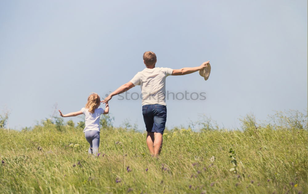 Similar – Image, Stock Photo happy father and daughter walking on summer meadow