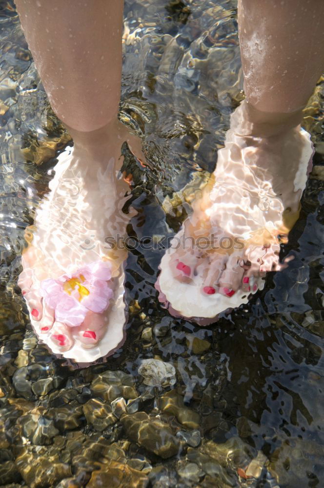 Similar – Dirty muddy bare feet with a pair of water boots on a muddy path