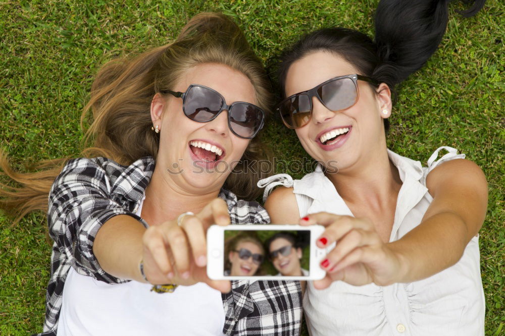 Similar – Beautiful women taking a selfie portrait in the park.