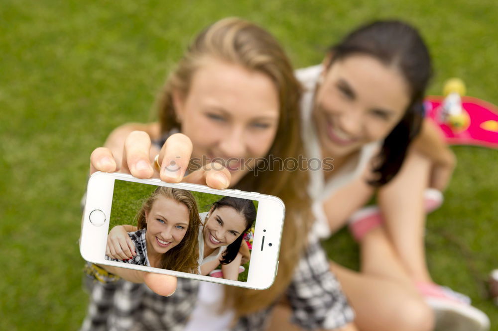 Beautiful women taking a selfie portrait in the park.