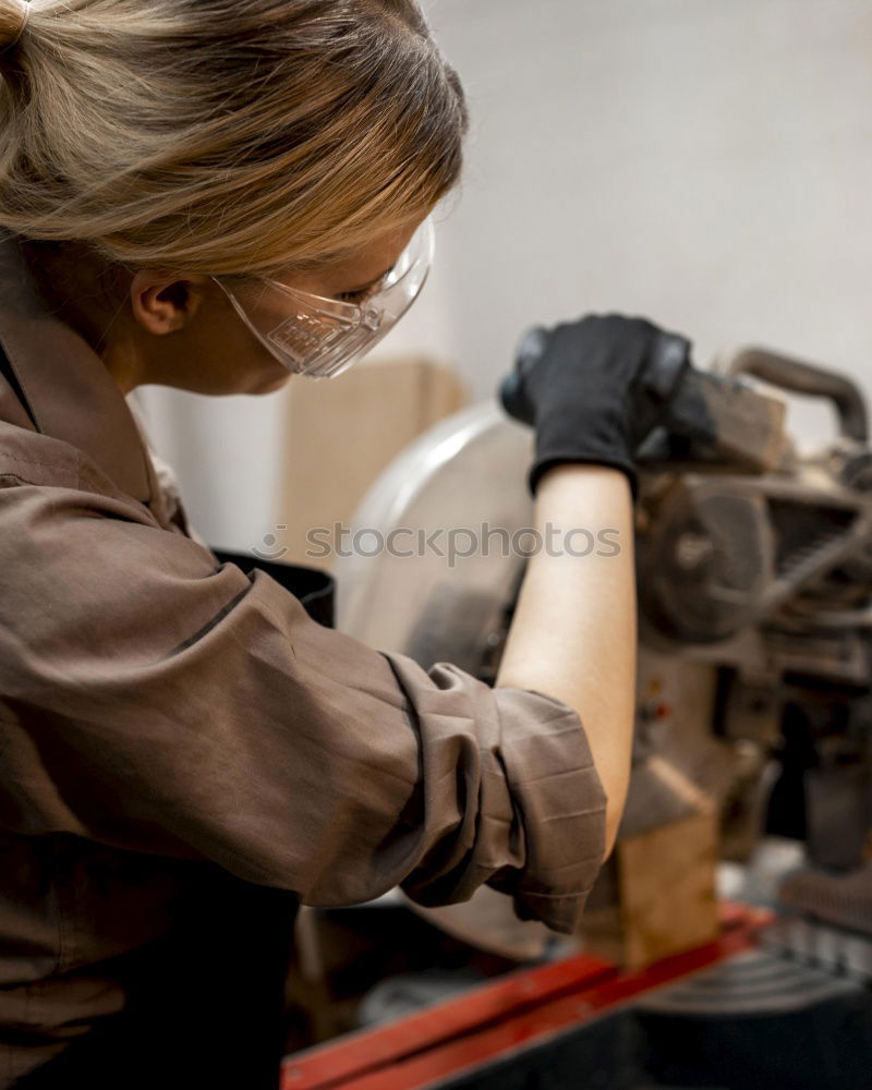 Similar – Image, Stock Photo female mechanic fixing a compressor enginge using a wrench