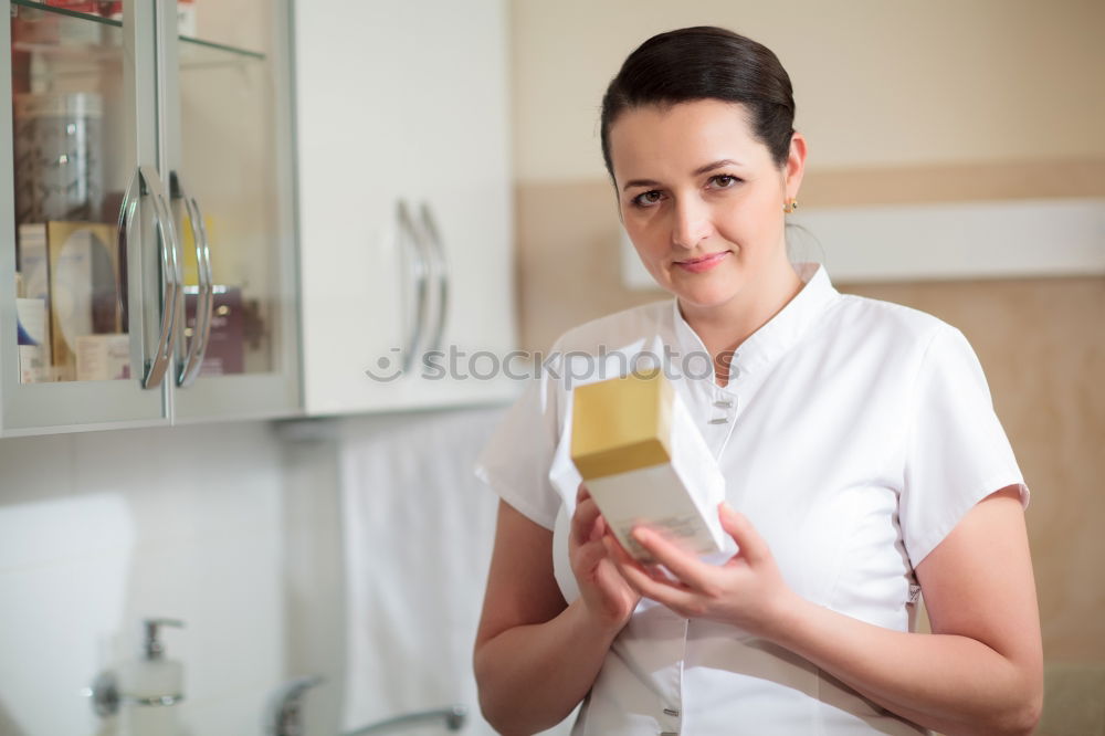 Similar – Female cosmetician applying a facial mask with special cosmetic brush. Beautiful cosmetician looking to the camera