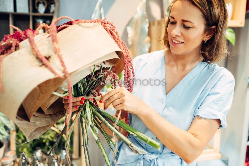 Similar – Woman smelling flower on market