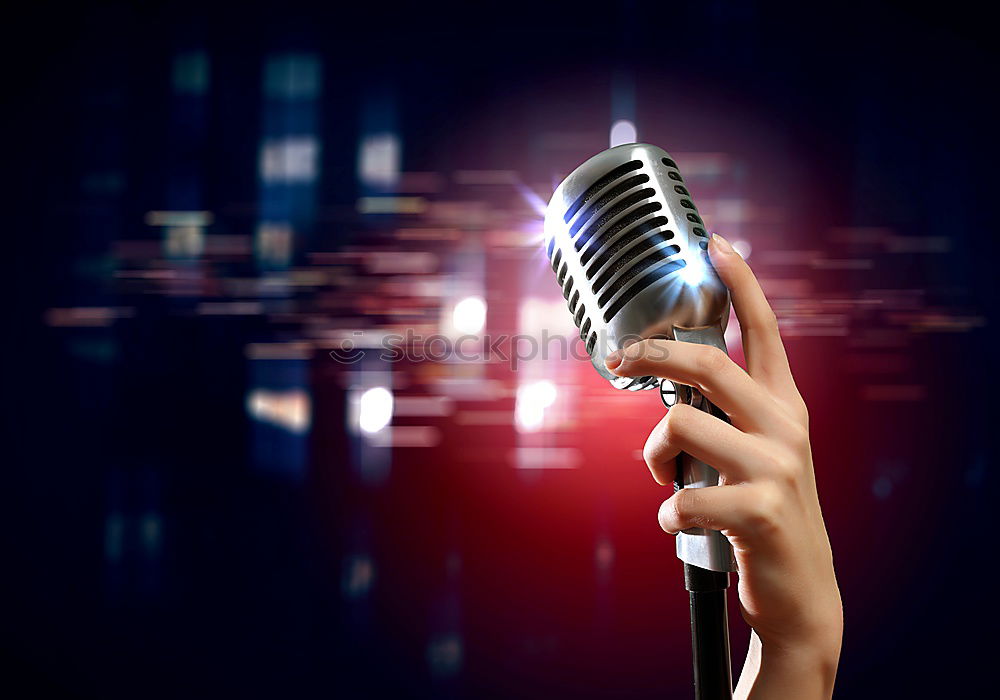 Similar – Woman holding microphone with two hands over black