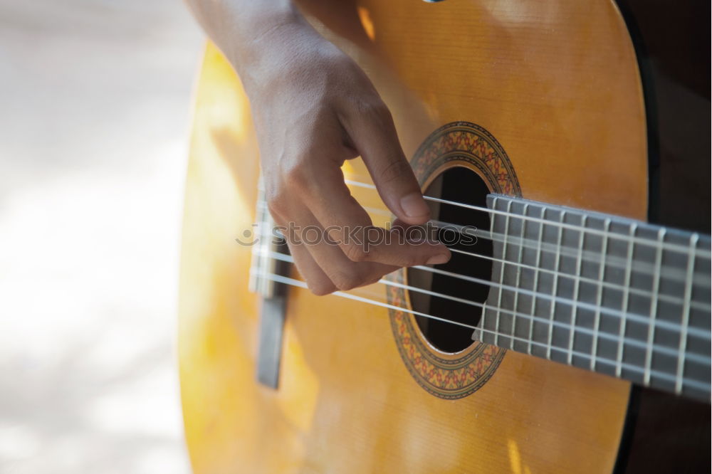 Similar – Image, Stock Photo Man playing guitar and composing music at home near a bright window on a sunny day. Casual musician sitting on the floor playing the guitar.