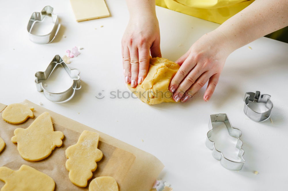 woman in bakery preparing sweets adding egg