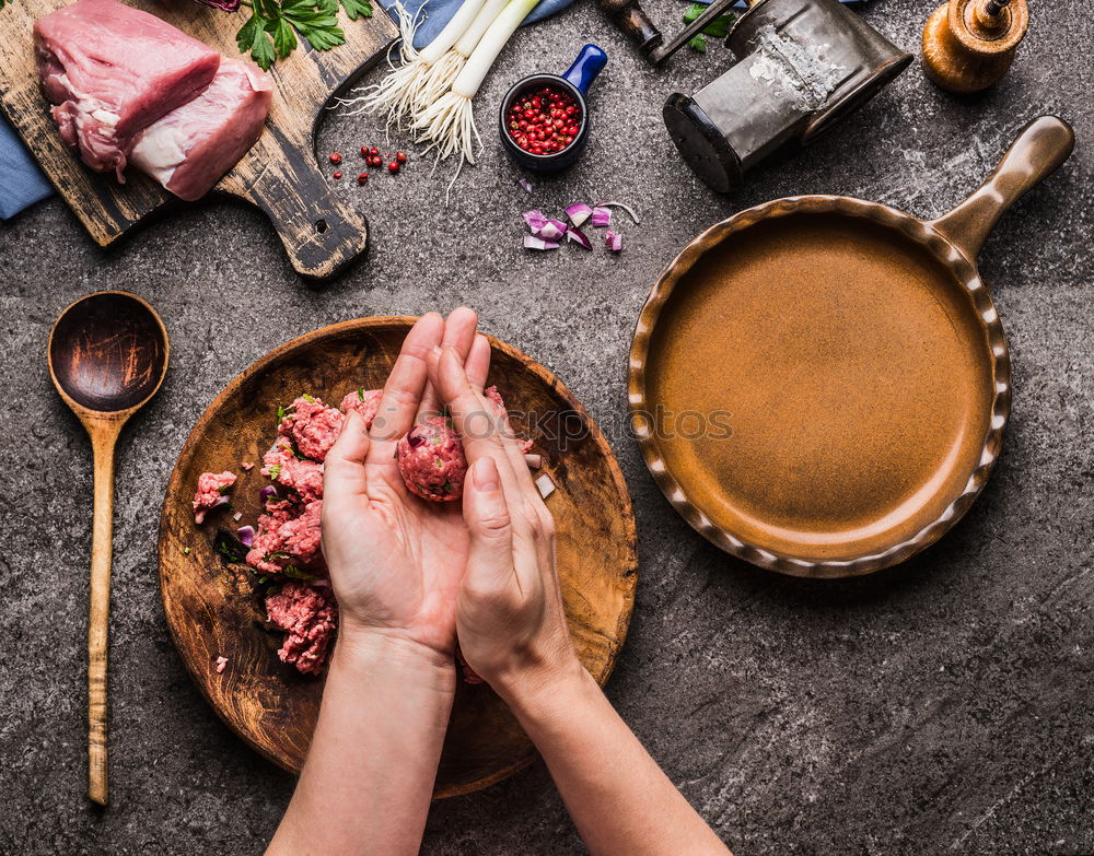 Female hands make meatballs