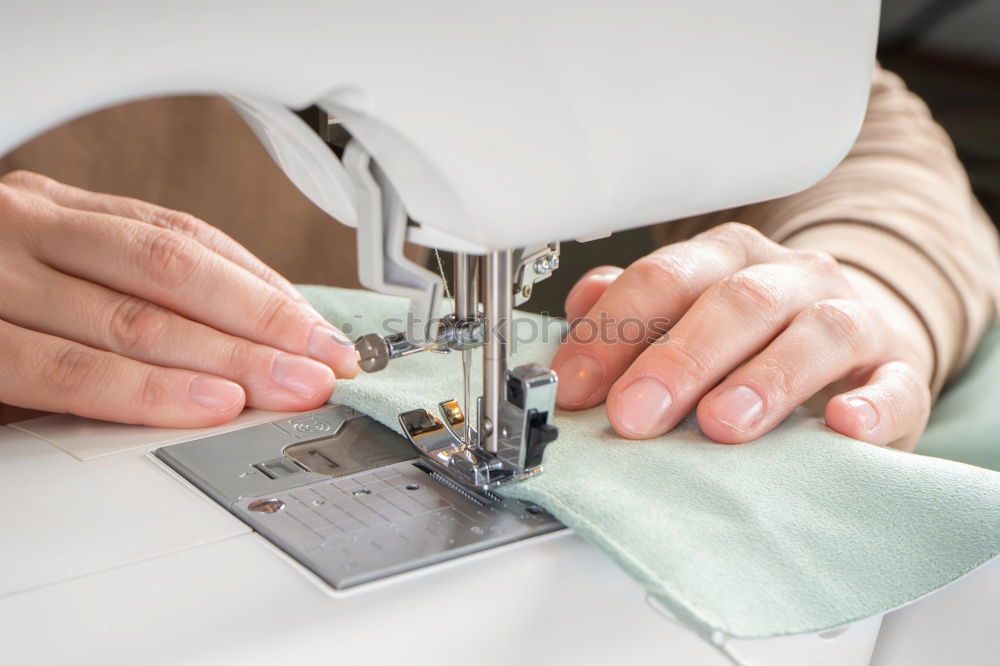 Similar – Women sew on sewing machine