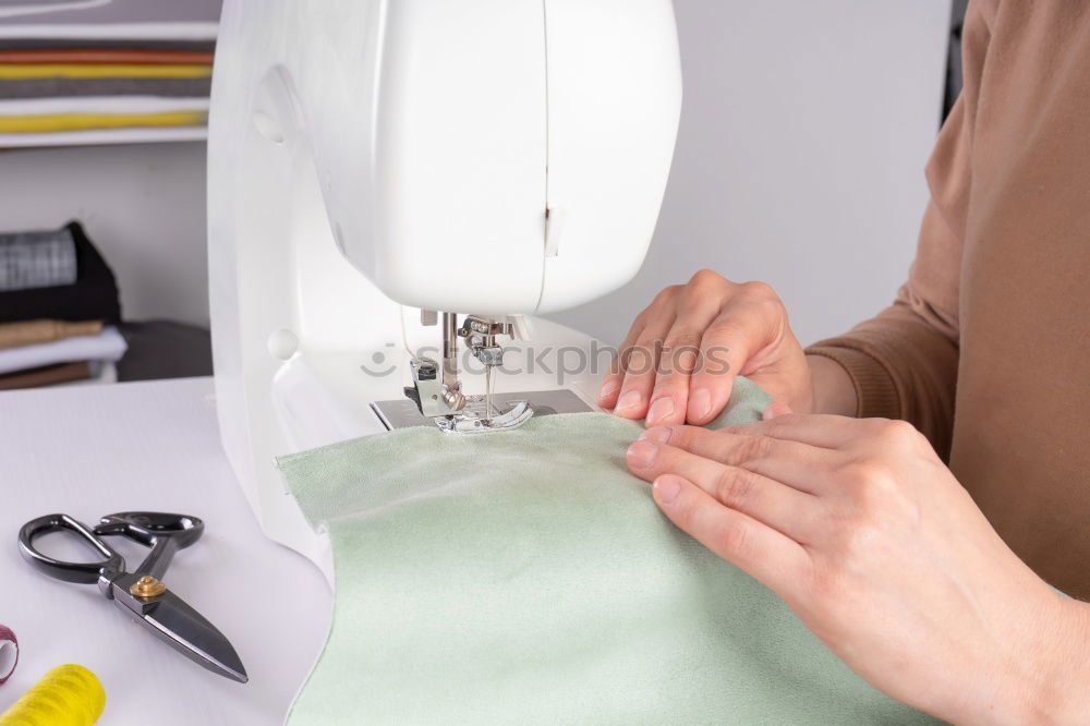 Similar – Women sew on sewing machine