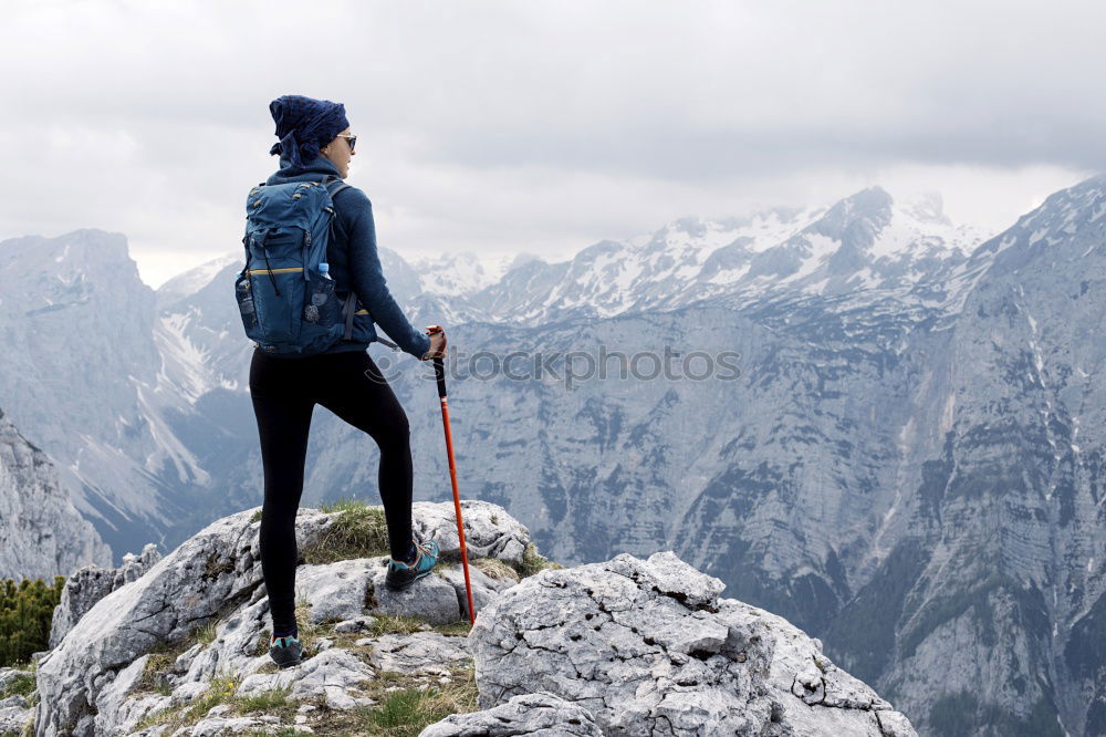 Similar – Image, Stock Photo Boy sitting on the rocks in the mountains and looking at a valley