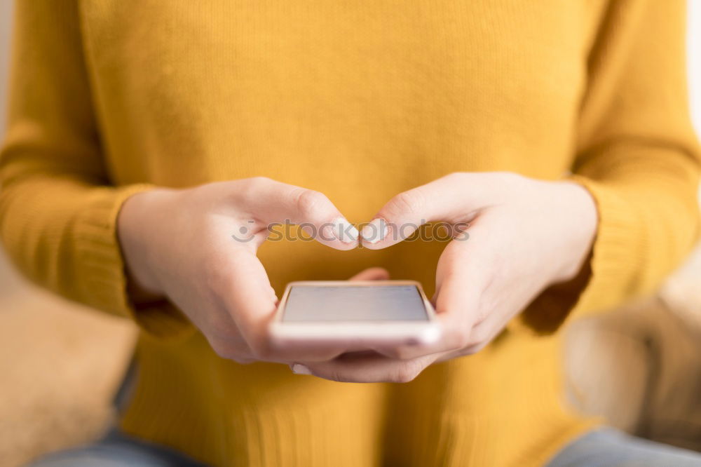 Closeup of woman’s hands using a smartphone