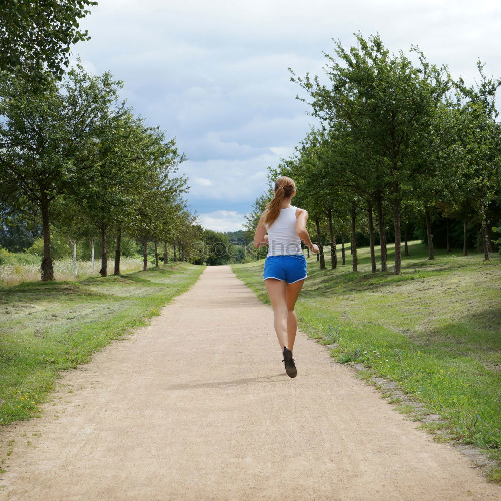 Similar – Healthy Woman Jogging in the Park with her Dog