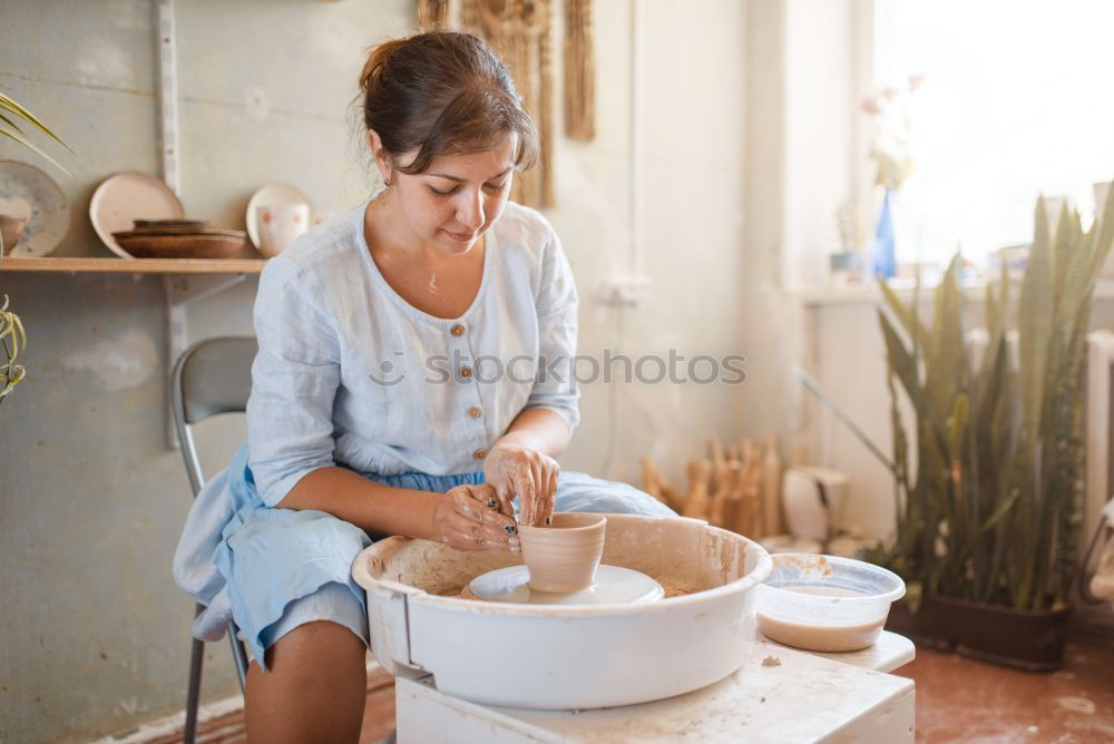 Senior woman sewing protective masks at home