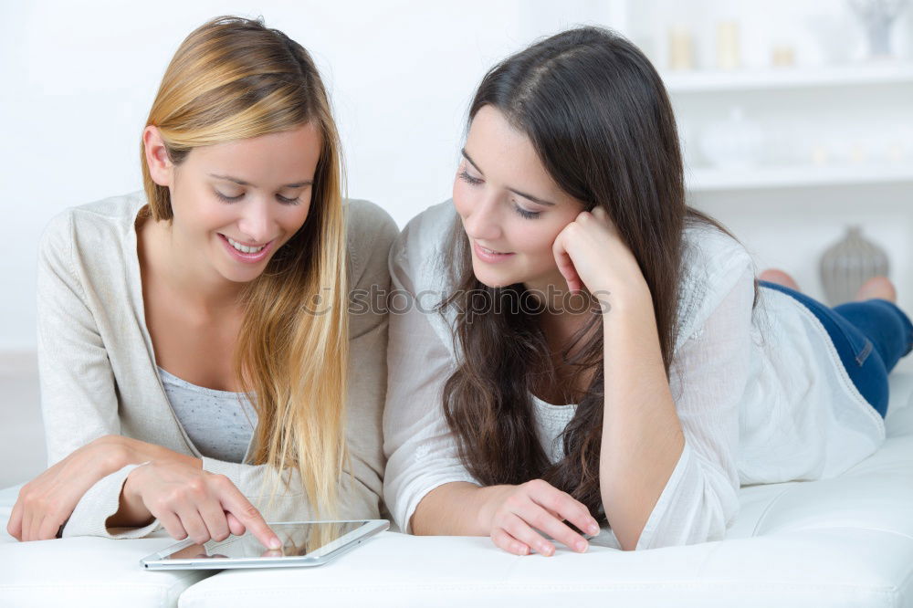 Image, Stock Photo Women at home sitting on sofa while using a tablet PC