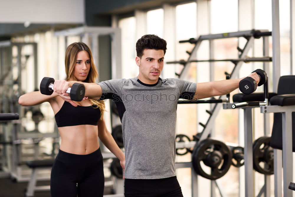 Similar – Man and woman personal trainers in the gym.