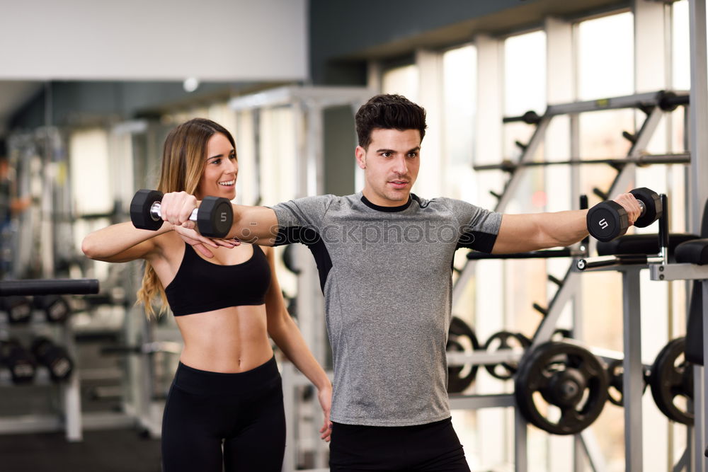 Similar – Female personal trainer helping a young man lift weights