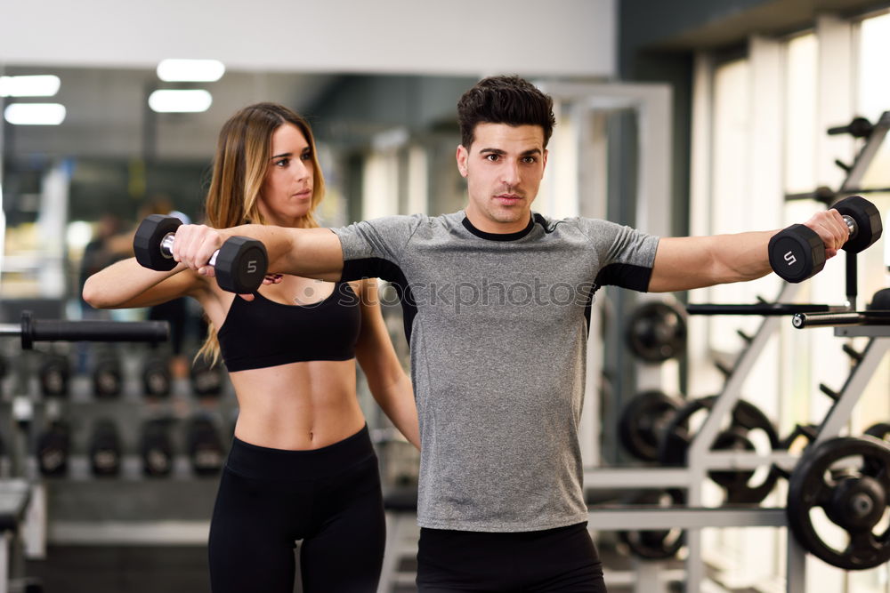 Similar – Man and woman personal trainers in the gym.