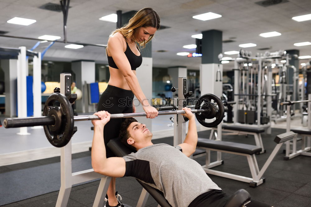 Image, Stock Photo Female personal trainer helping a young man lift weights