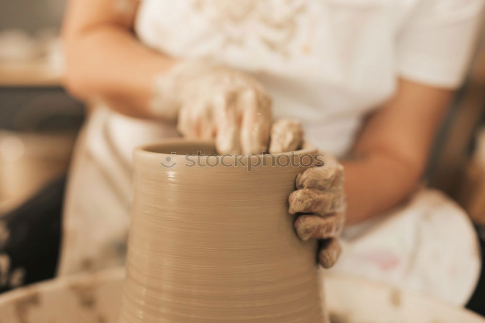 Similar – Image, Stock Photo Young female sitting by table and making clay or ceramic