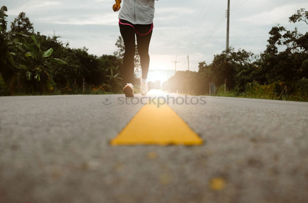 Similar – Young fitness woman runner running on city bridge.