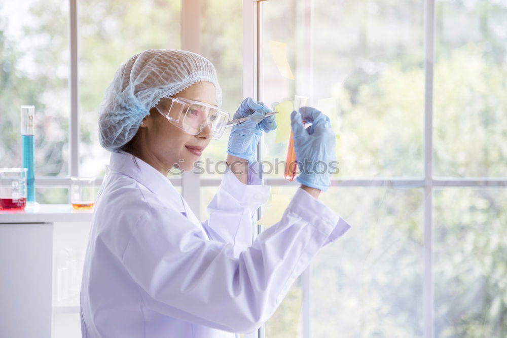 Similar – Image, Stock Photo Woman holding flask in lab