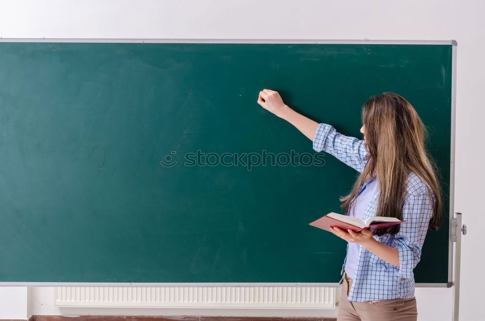 Similar – Pupil writing on the blackboard