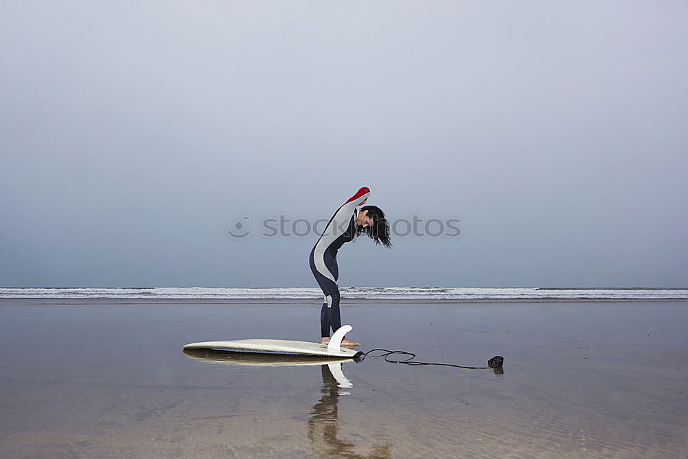 Similar – Man in wetsuit swimming in ocean