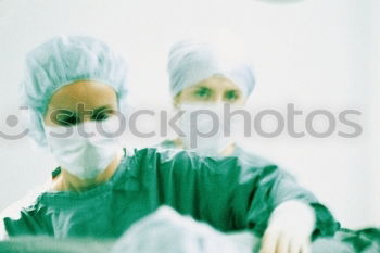 Similar – Image, Stock Photo Team of Surgeons Operating.