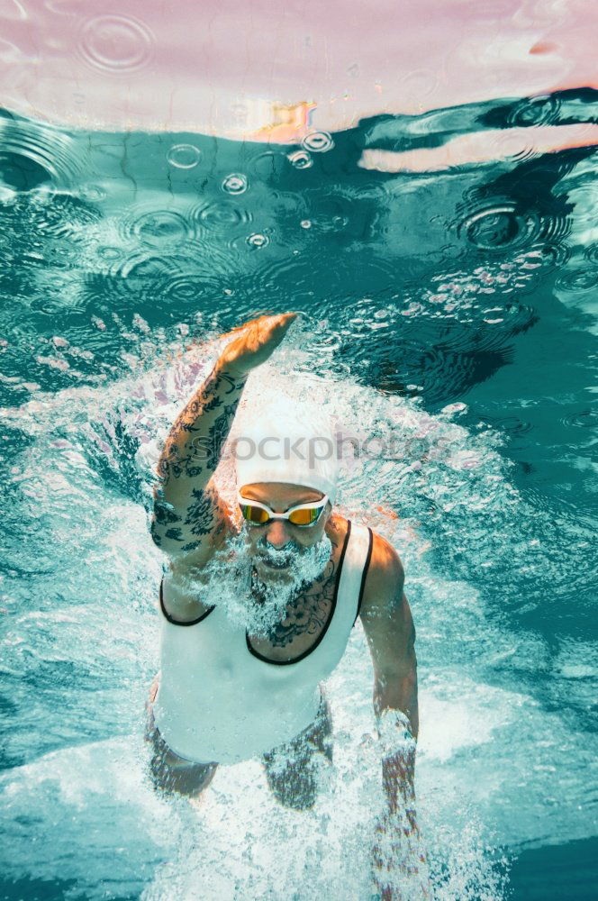 Similar – Man in wetsuit swimming in ocean