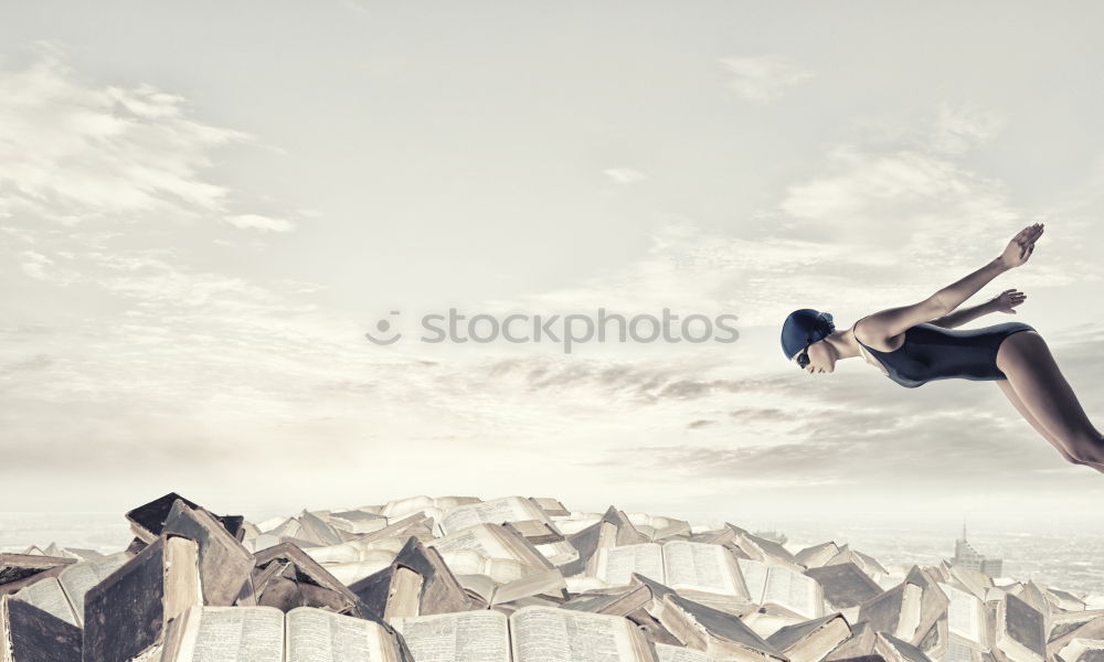 Similar – Woman jumping barefoot over blue rubber hills