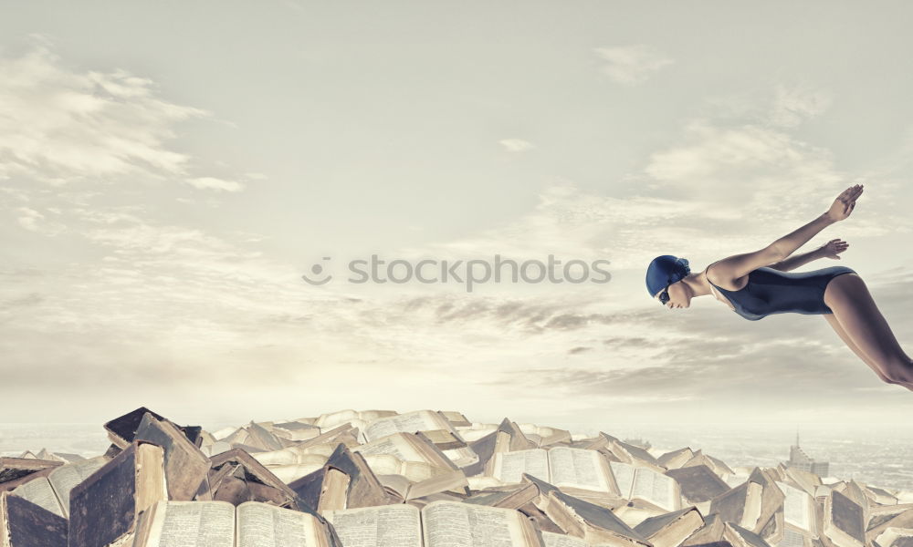 Similar – Woman jumping barefoot over blue rubber hills