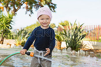 Similar – adorable boy watering the plants