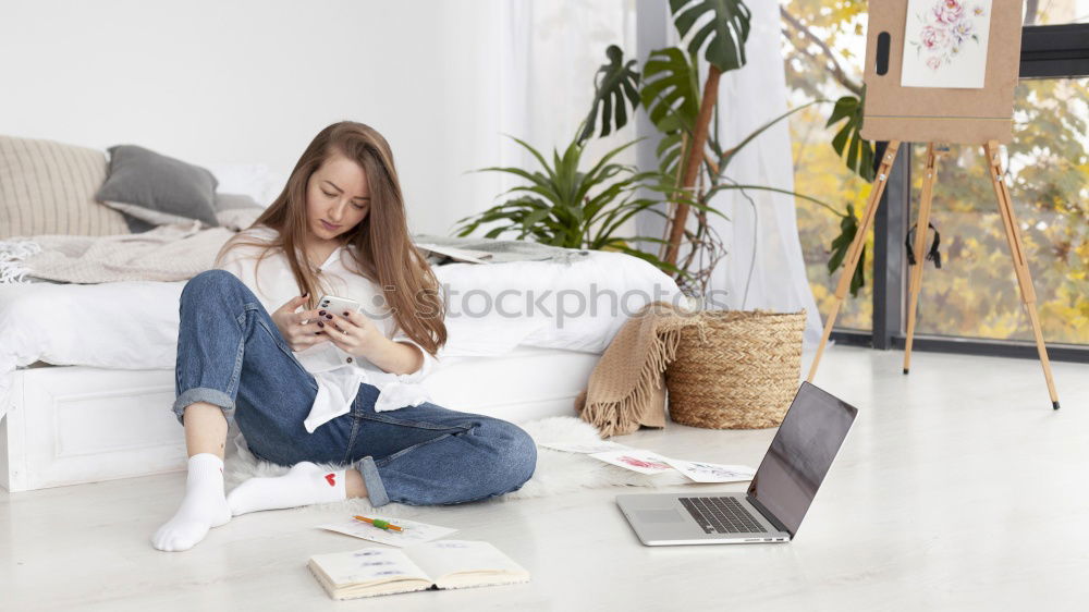 Similar – african happy woman lying on couch with laptop